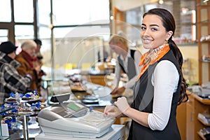 Shopkeeper and saleswoman at cash register or cash desk