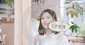 Shopkeeper turning open sign