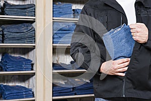 Shoplifter stealing denim