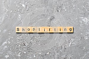 Shoplifting word written on wood block. Shoplifting text on cement table for your desing, Top view concept