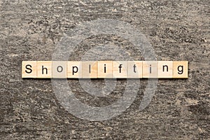 Shoplifting word written on wood block. Shoplifting text on cement table for your desing, Top view concept