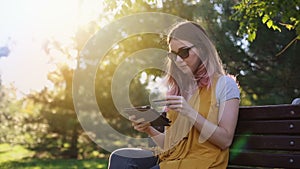 Shopper girl buying online with a laptop and credit card lying in a park in summer