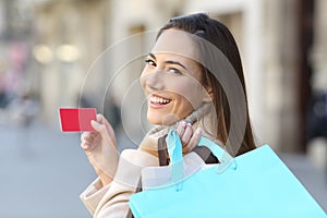 Shopper holding shopping bags and credit card photo