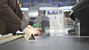 Shopper paying for products at checkout. Foods on conveyor belt at the supermarket. Cash desk with cashier and terminal photo