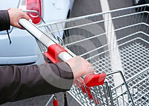 Shopper pushing empty cart