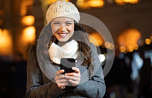 Shopper woman buying online on the smart phone at Christmas. People shopping communication concept