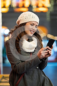 Shopper woman buying online on the smart phone at Christmas. People shopping communication concept