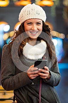 Shopper woman buying online on the smart phone at Christmas. People shopping communication concept