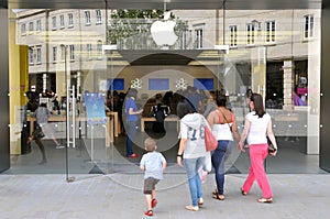 Shoppers Walk to an Apple Store