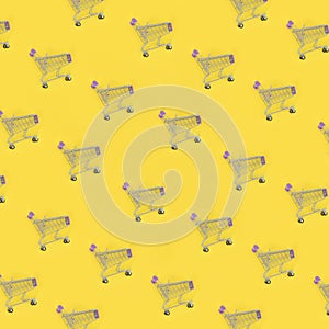 Shopping addiction, shopping lover or shopaholic concept. Many small empty shopping carts perform a pattern on a pastel colored