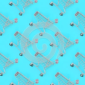 Shopping addiction, shopping lover or shopaholic concept. Many small empty shopping carts perform a pattern on a pastel colored