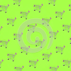 Shopping addiction, shopping lover or shopaholic concept. Many small empty shopping carts perform a pattern on a pastel colored