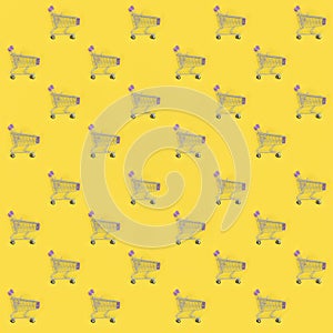 Shopping addiction, shopping lover or shopaholic concept. Many small empty shopping carts perform a pattern on a pastel colored