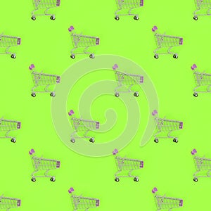 Shopping addiction, shopping lover or shopaholic concept. Many small empty shopping carts perform a pattern on a pastel colored