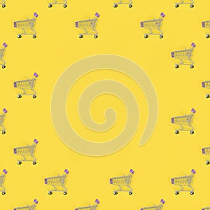 Shopping addiction, shopping lover or shopaholic concept. Many small empty shopping carts perform a pattern on a pastel colored