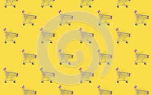 Shopping addiction, shopping lover or shopaholic concept. Many small empty shopping carts perform a pattern on a pastel colored