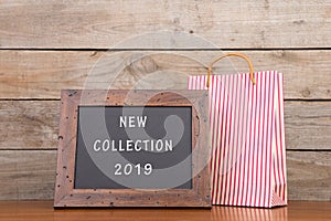 Shopping bag and blackboard with text "New collection 2019 photo