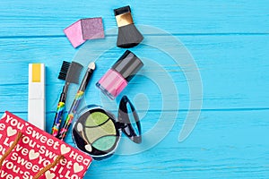 Shopping bag and cosmetics, wooden background.