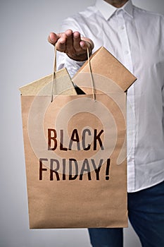 Shopping bag full of boxes and text black friday