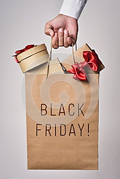 Shopping bag full of gifts and text black friday