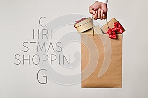 Shopping bag with gifts and text christmas shopping