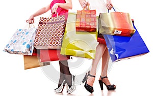 Shopping bag and group of leg in shoes.