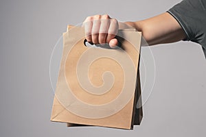 A shopping bag in a male hand