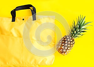 Shopping bag with pineapple on the yellow background, delivery, takeaway