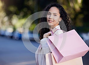 Shopping bag, portrait and woman in city street for fashion, sale or mall cashback, product or gift. Store, discount or
