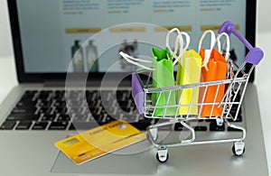 Shopping bag in a trolley on a laptop computer,Online shopping or ecommmerce concept