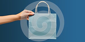 Shopping bag in woman's hand on blue background. Mockup design with blank space. Add text or logo. Generative Ai