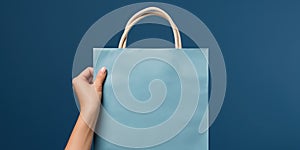 Shopping bag in woman's hand on blue background. Mockup design with blank space. Add text or logo. Generative Ai