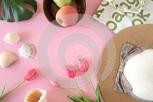 Shopping bags and accessories for summer vacation, fruit and sun hat in pink background