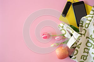 Shopping bags and accessories for summer vacation, fruit and sun hat in pink background,