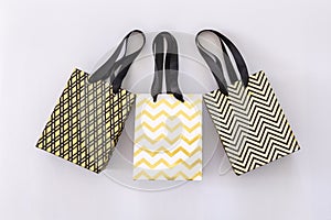 Shopping bags, gift boxes in modern style on white background. Golden stars, black geometric lines- fashion modern design. Minimal