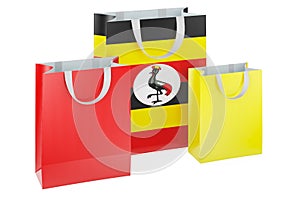 Shopping bags with Ugandan flag. Shopping in Uganda, concept. 3D rendering