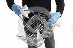 Shopping basket being cleaned by hands with gloves, isolated on white background