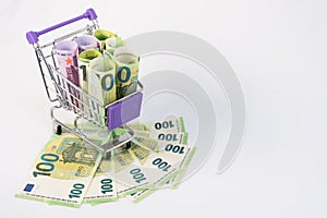 The shopping basket contains EU banknotes. The concept of selling, buying currency. Consumer basket. Saving. Trading on