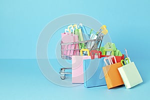 Shopping basket full of paper bags. Sesonal sale, online deals, discounts, promotions idea