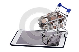 Shopping basket full of US coins on a tablet pc isolated on a white background