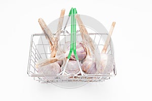 Shopping basket with garlic bulbs on white background