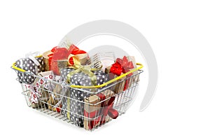 Shopping basket with gifts on white background