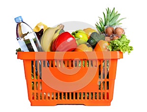 Shopping basket with grocery products on background