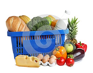 Shopping basket and grocery products on background