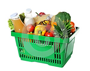 Shopping basket with grocery products on white