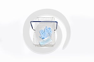 Shopping basket with hand gloves and mouth mask, isolated on white background