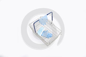 Shopping basket with hand gloves and mouth mask, isolated on white background