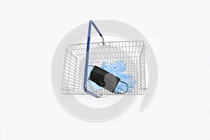 Shopping basket with hand gloves and mouth mask, isolated on white background
