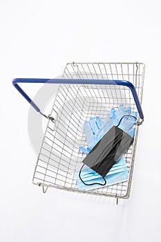 Shopping basket with mouth protection and hand gloves, isolated on white background