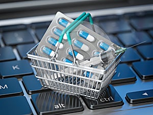 Shopping basket with pills and syrringe  on  laptop keyboard..  Buying  pharma and medicines online